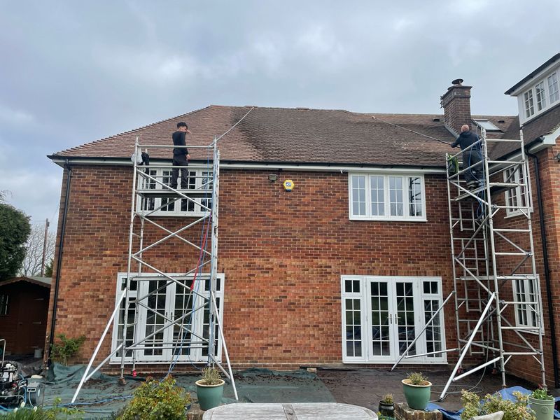Roof cleaning carried out safely from scaffold towers by The Roof Moss Cleaners in Yaxley